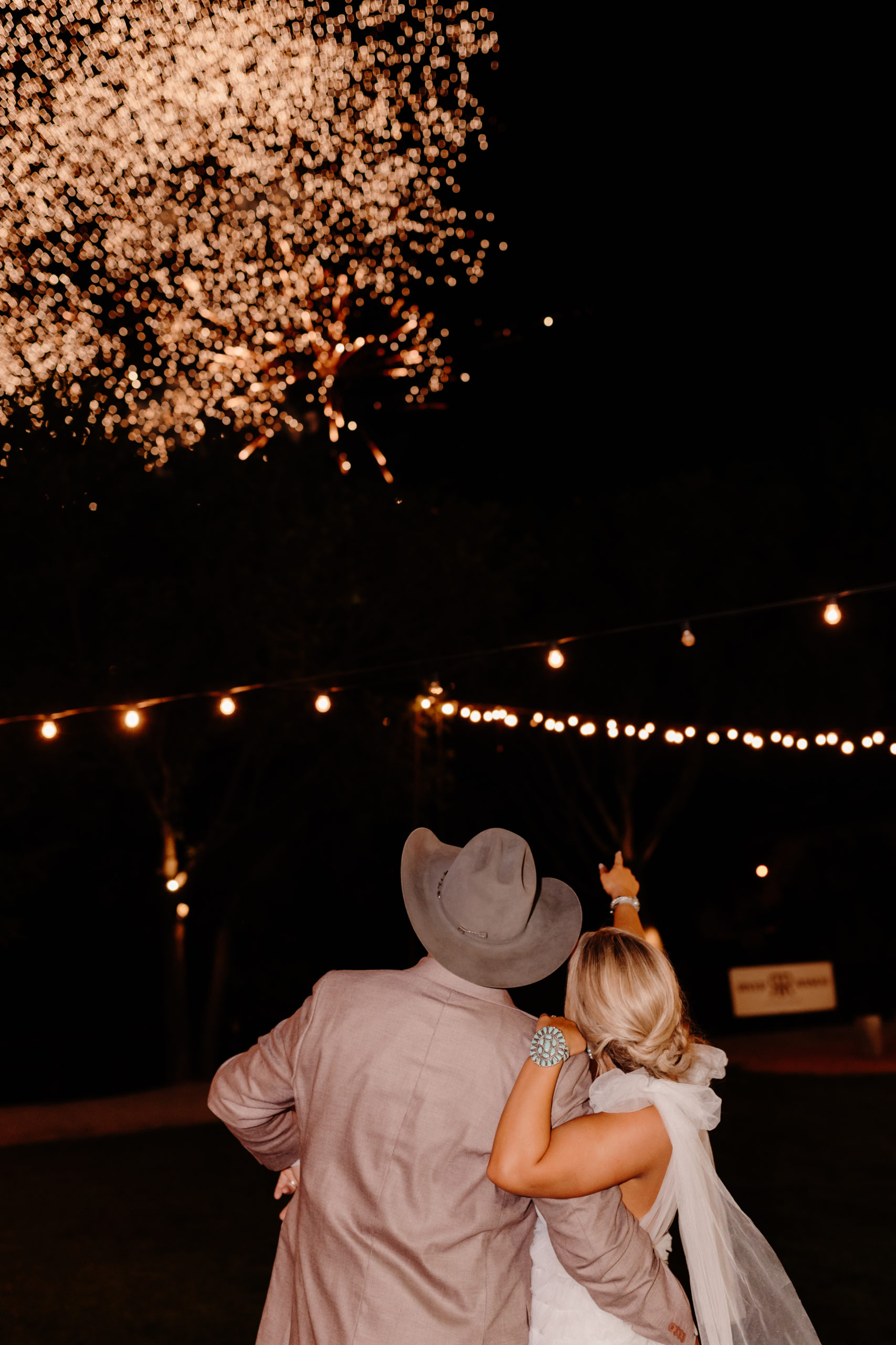 bride and groom watch firework display