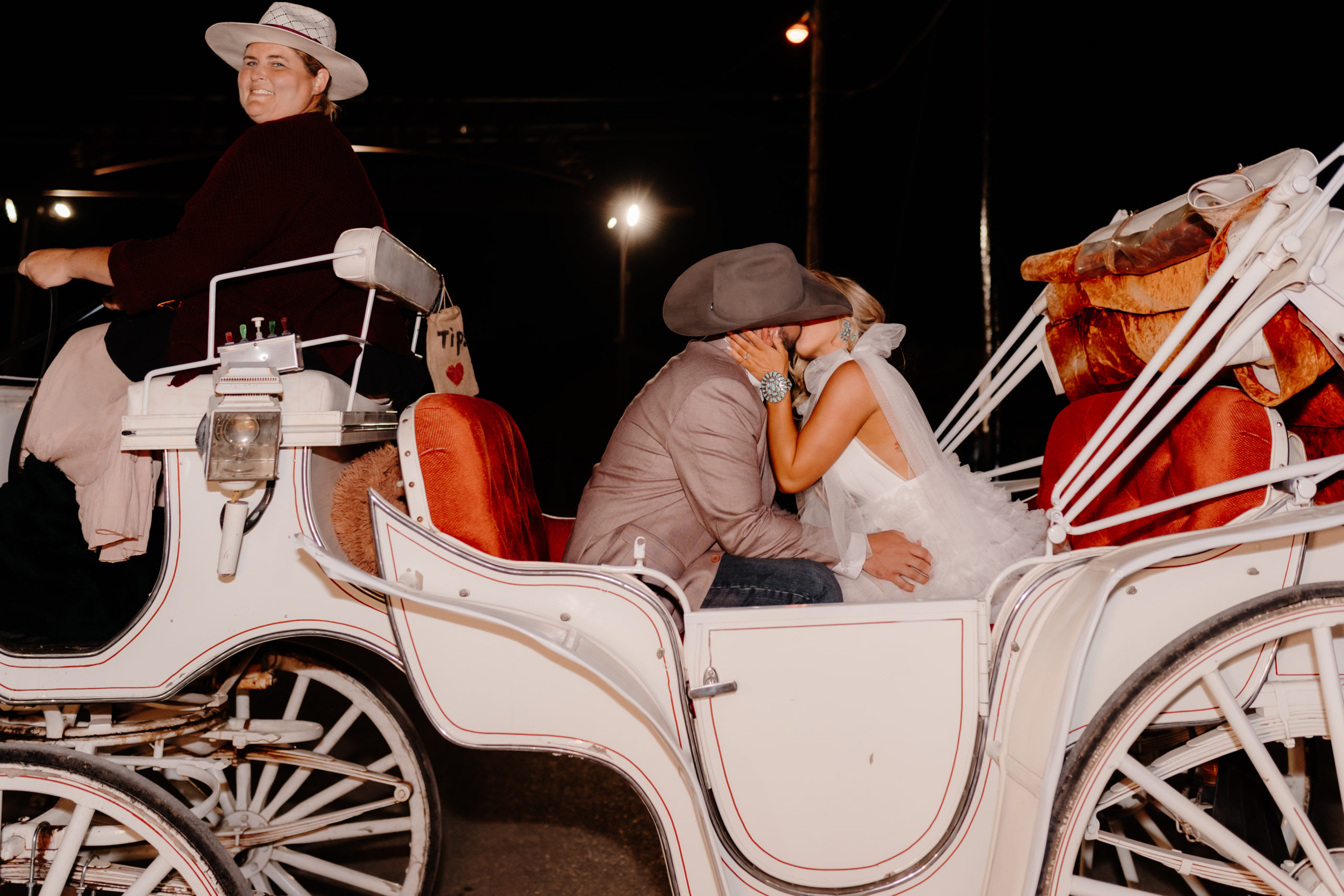 bride and groom ride in horse and carriage