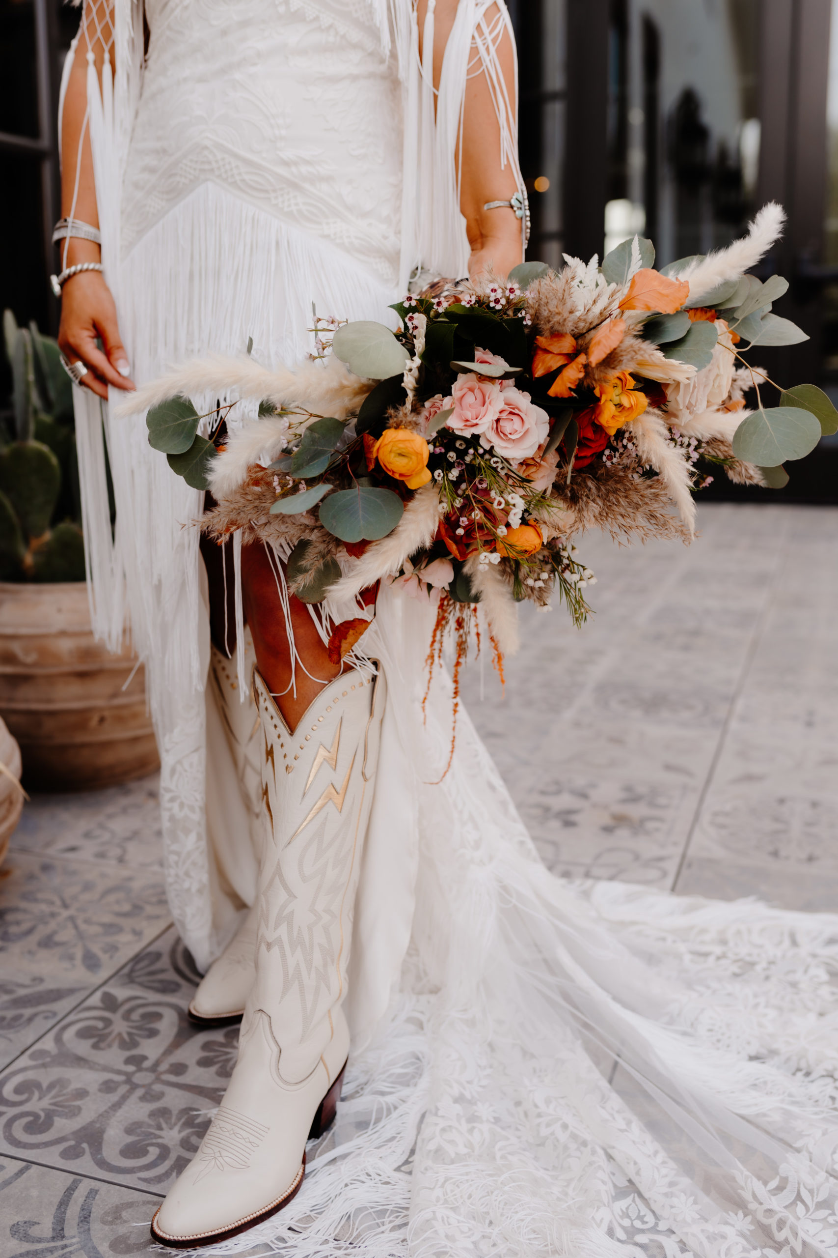 bride cowgirl boots and bouquet