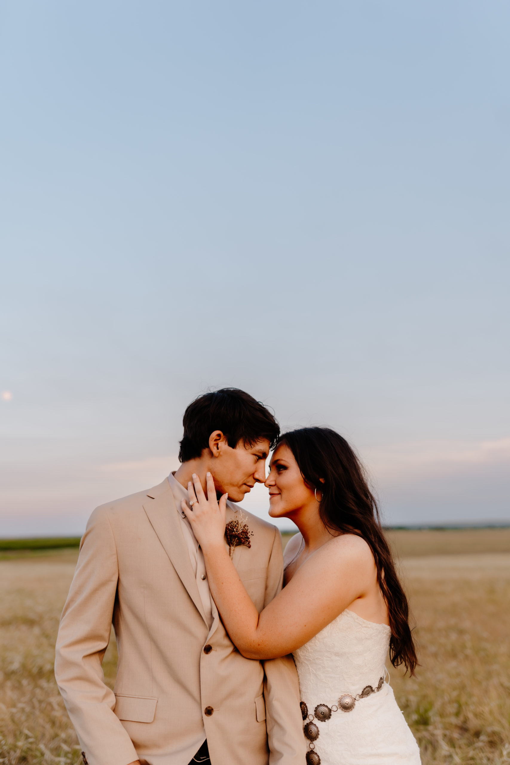 bride and groom in field